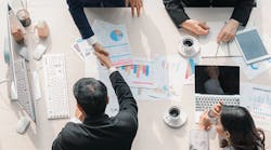 1660317240718 Fourbusinesspeoplemakingagreementovertablewithpapersfeaturingdatacharts 1660317240718 Fourbusinesspeoplemakingagreementovertablewithpapersfeaturingdatacharts