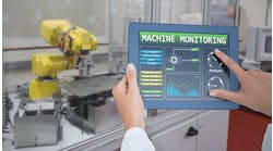 Person-monitors-machine-using-tablet