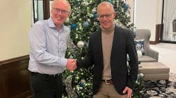 Marcel van Helten, CEO, Red Lion Controls, and Staffan Dahlstr&ouml;m, CEO, HMS Networks, shake hands after signing.