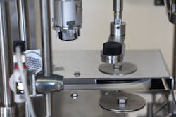 Figure 1: TurboFil&rsquo;s Acrobat Chuck Capper features a two-chuck system with a chasing chuck that automatically locates the next bottle along the belt.