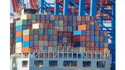 Container ship with colorful containers on the vessel quayside in the freight terminal of the harbor