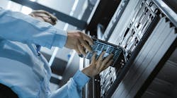 Low Angle Shot In Fully Working Data Center IT Engineer Installs Hard Drive into Server Rack