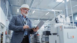 Heavy Industry Specialist Working on Laptop Computer.