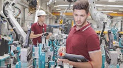 two engineers check functionality while commissioning a production line in welding shop two engineers check functionality while commissioning a production line in welding shop