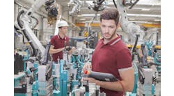 two engineers check functionality while commissioning a production line in welding shop two engineers check functionality while commissioning a production line in welding shop