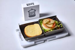 Figure 1: A freshly cooked burger is placed into a burger box with a QR code, which will let the robots know how to serve up the burger.