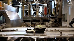 Figure 2: As it moves along the conveyor, the IRB 360 FlexPicker hygienically performs high-speed topping selection, guided by the data stored in the QR code. Next, the YuMi steps in to collaborate on the final assembly of the burger.